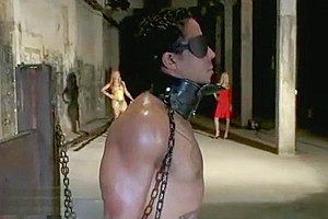 Two busty trannies fuck bdsm dude on a table